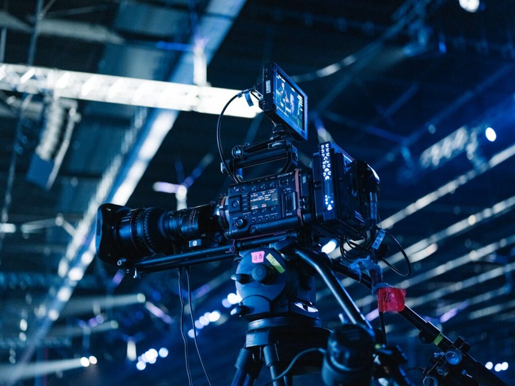Close-up of professional video camera setup in a well-lit indoor event venue.
